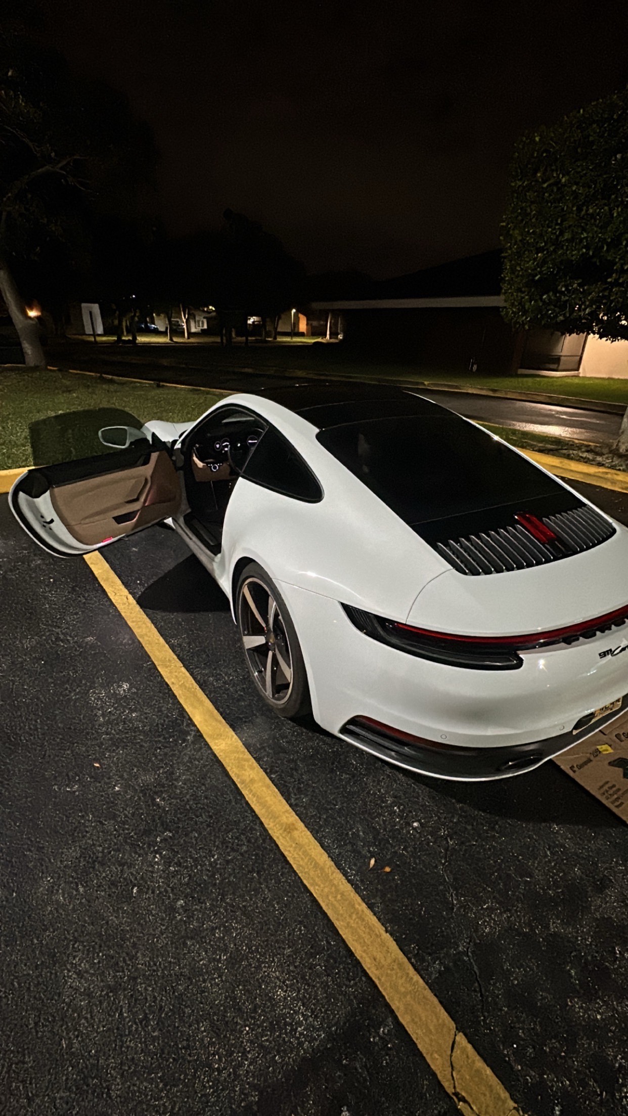 Aryone Thomas with white Porsche 911 - Success in real estate wholesaling